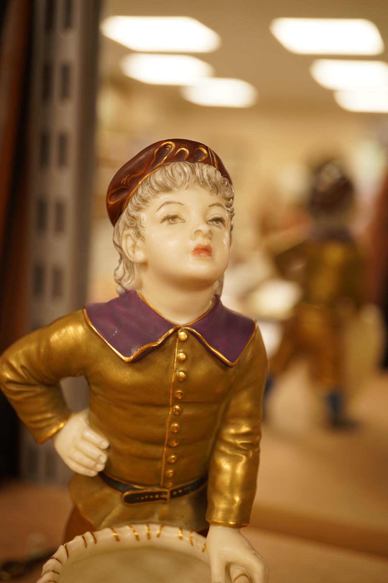A late 19th century Royal Worcester figure of a boy with basket, 17.5cm high